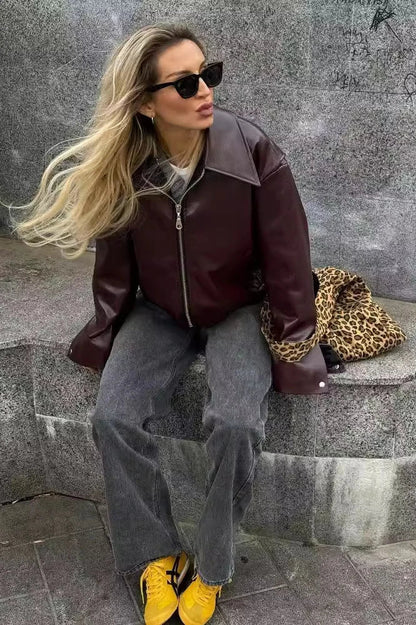 Amaranth - Women's deep burgundy faux leather zip-front cropped bomber jacket with a wide collar, styled over a black top and dark denim.